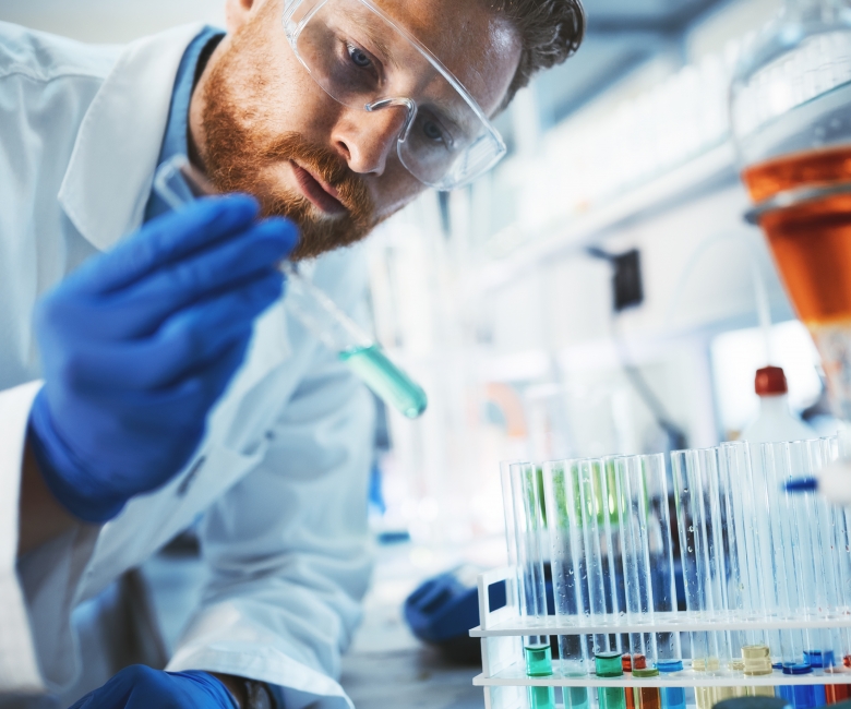 Male attractive student of chemistry working in laboratory